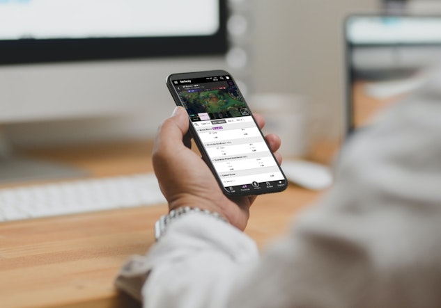 Holding my phone watching Betway esports League of Legends stream